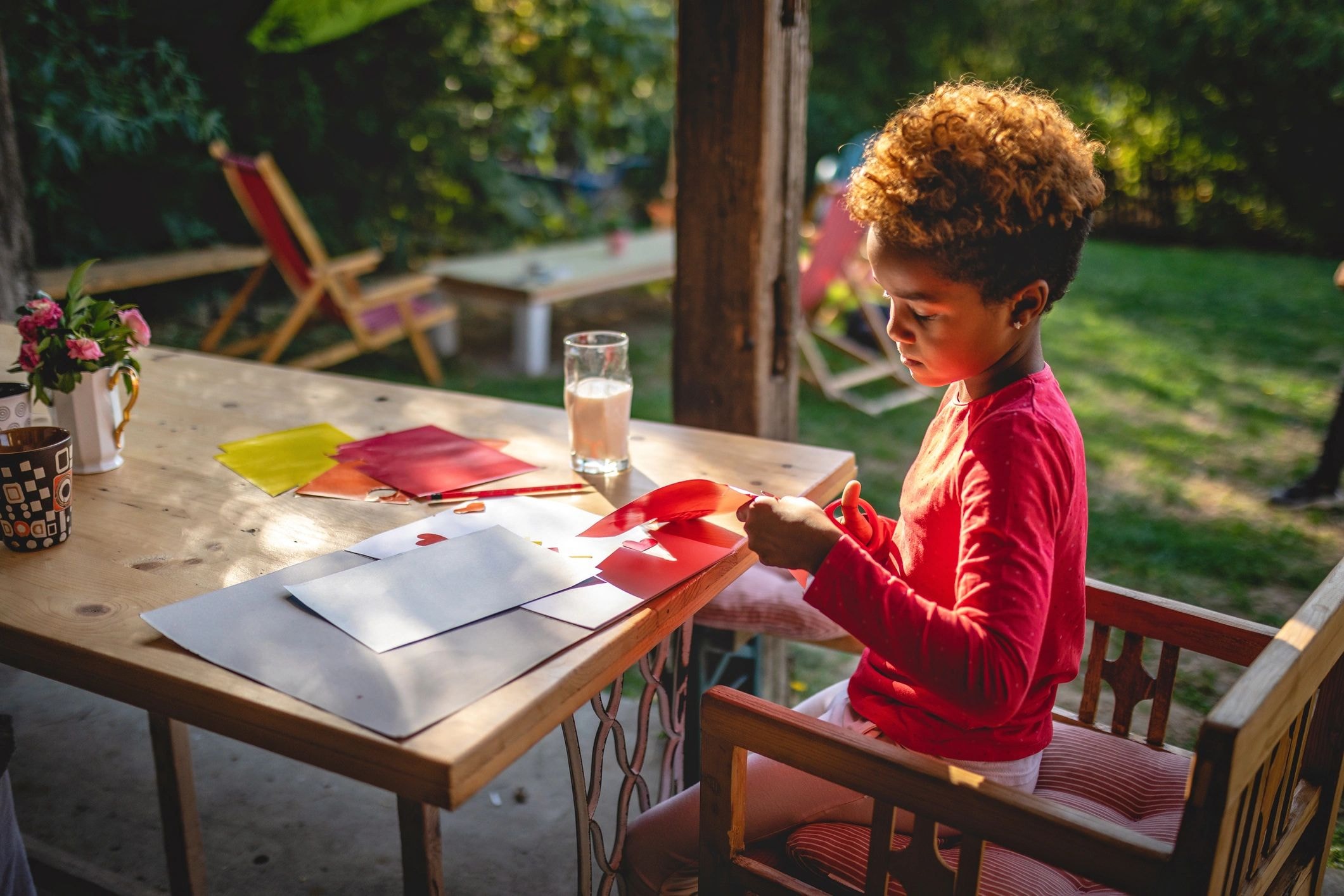 Child doing craft activity outdoors