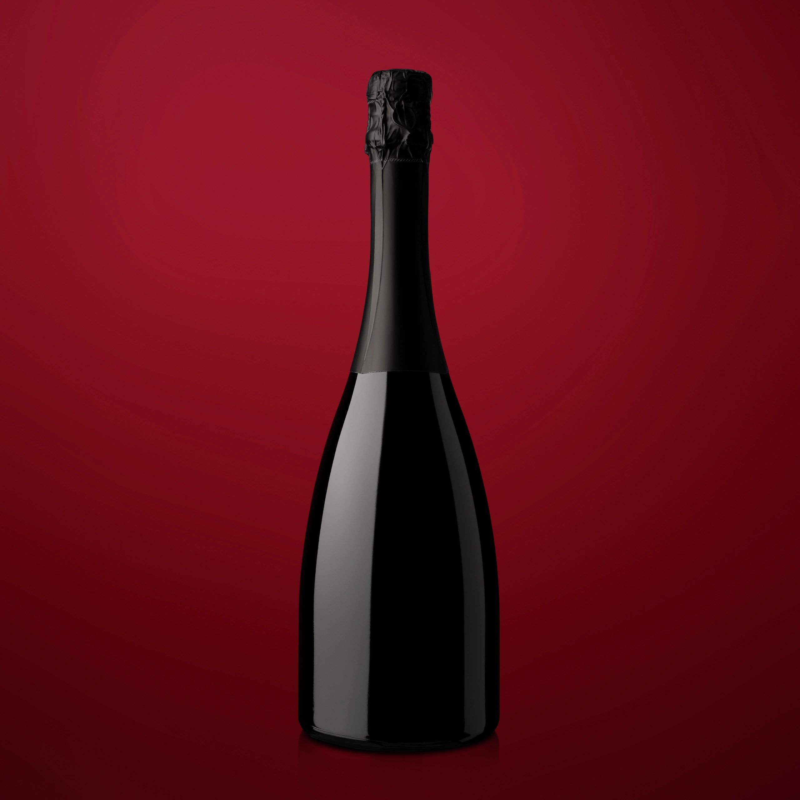 Sleek black wine bottle on burgundy background